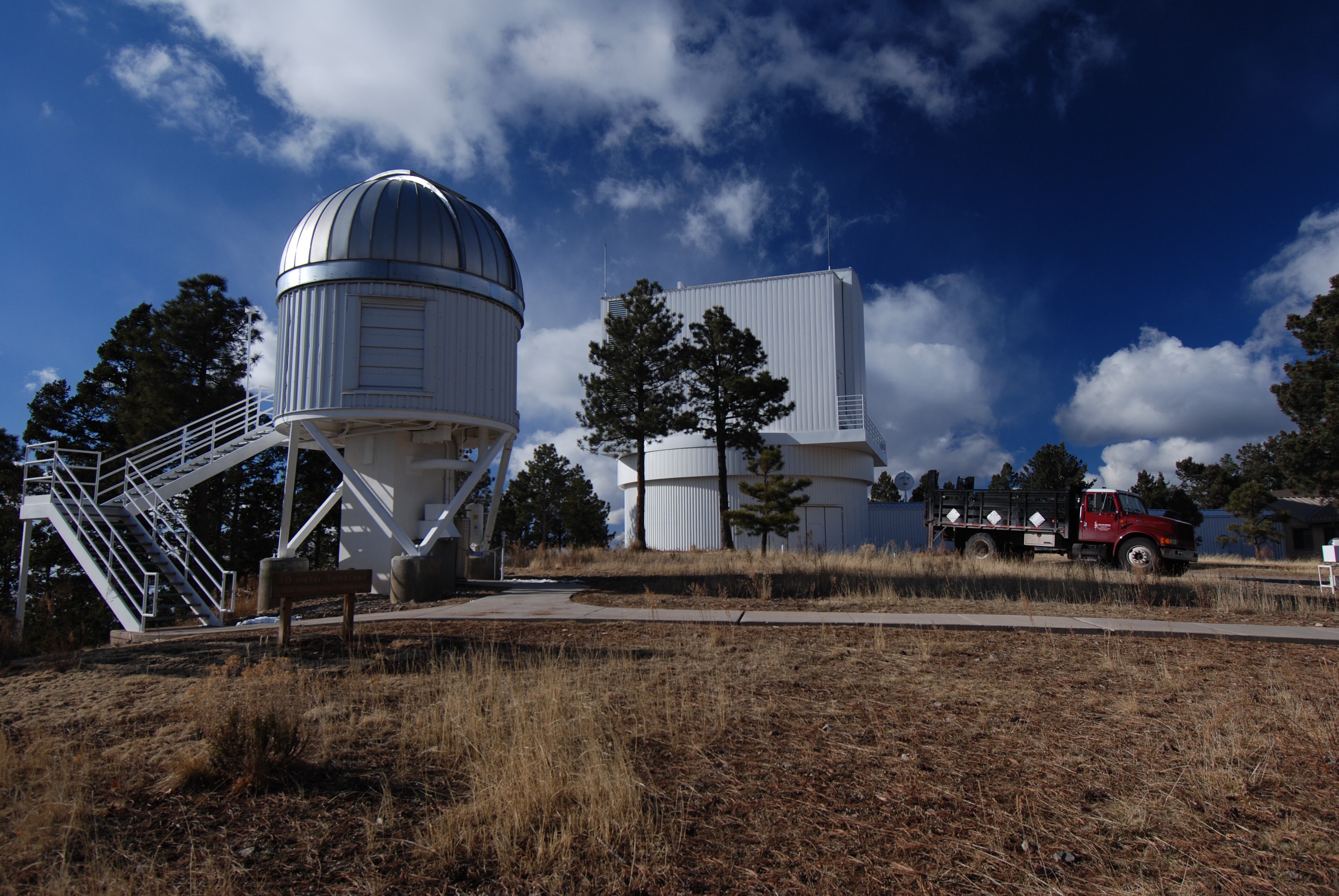 The NMSU 1 m dome at Apache Point Observatory in south east New Mexico in the south west of the United States. The larger enclosure in the background is the ARC 3.5 m telescope (image taken from <a target="_blank" href="http://adsabs.harvard.edu/abs/2010AdAst2010E..46H" rel="noopener noreferrer">Holtzman et al. 2010</a>).
