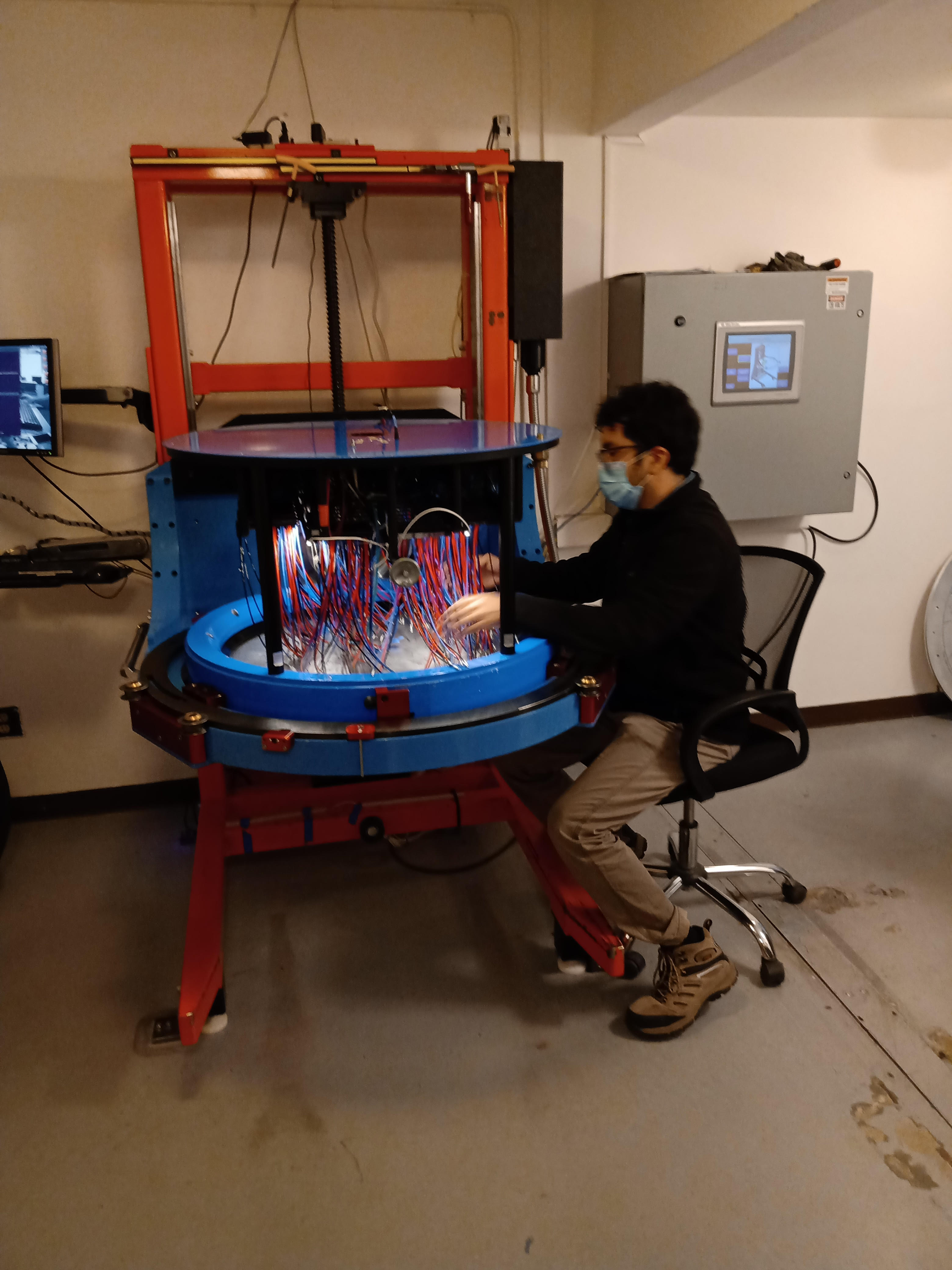 An APOGEE-2S observer places fibers into the plugplate.